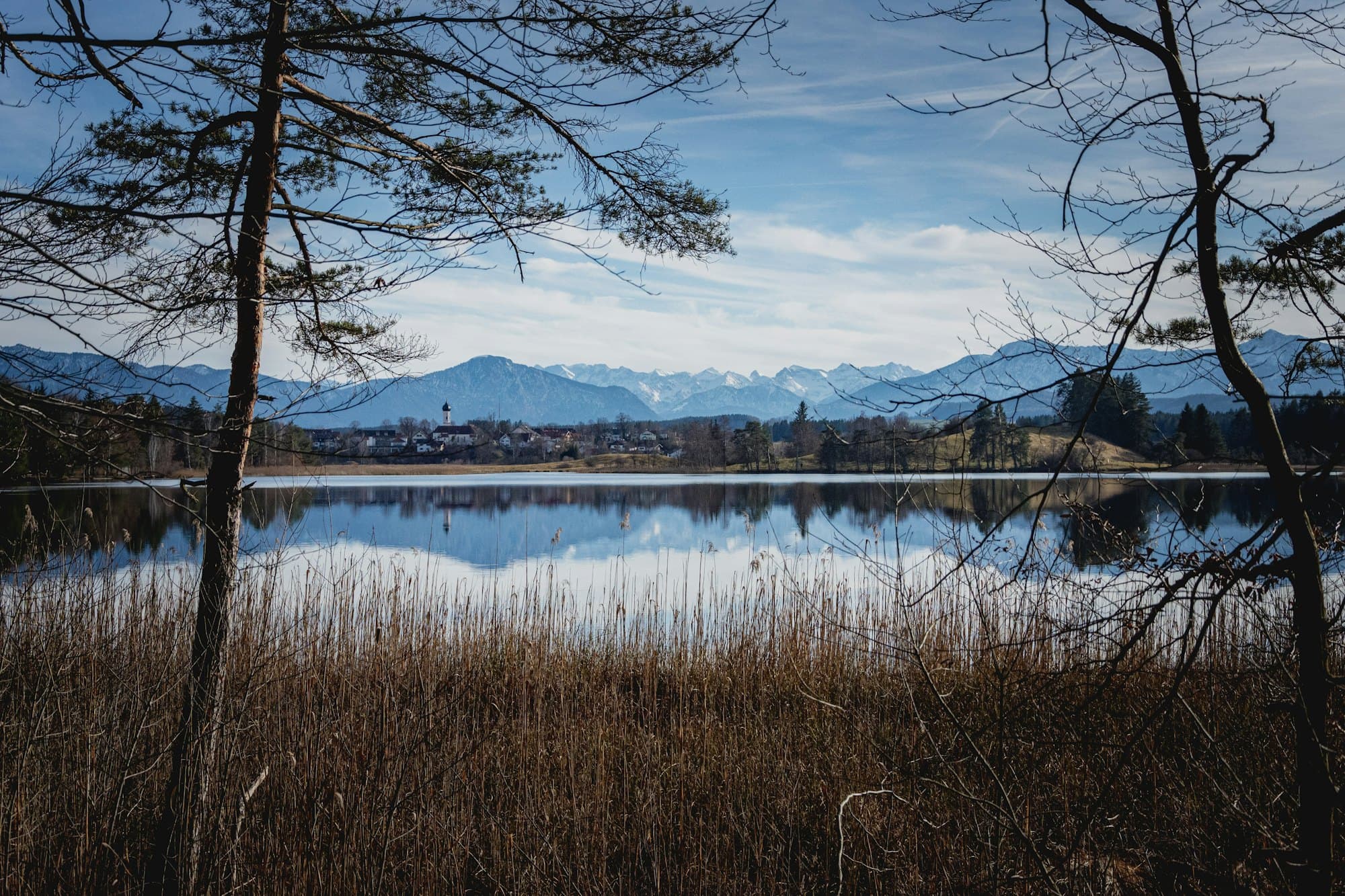 Alpine lake reflecting forested hills