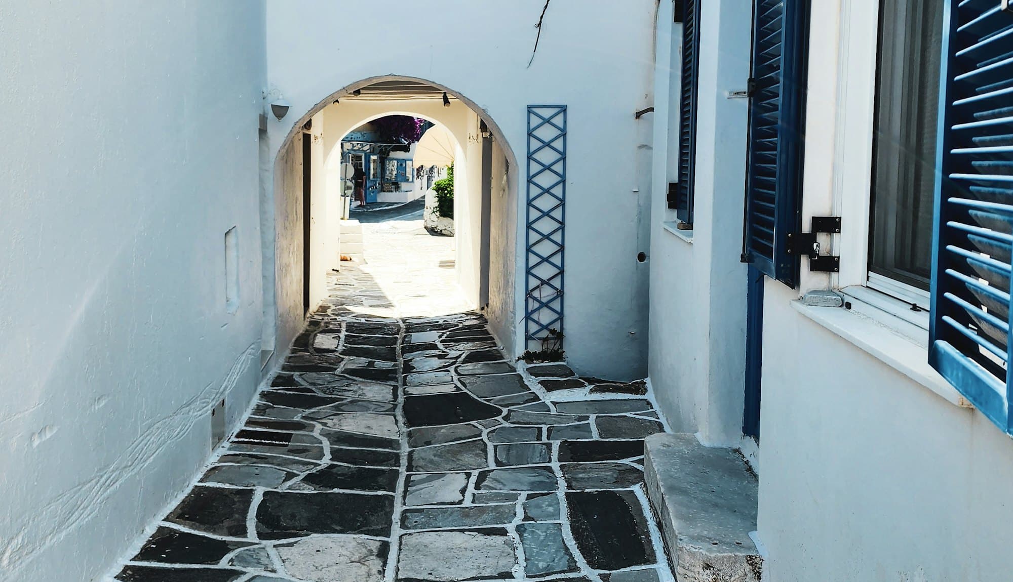 Blue shutters in a Greek island alley