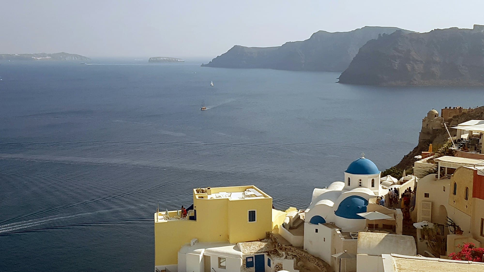Whitewashed Greek island town above the sea