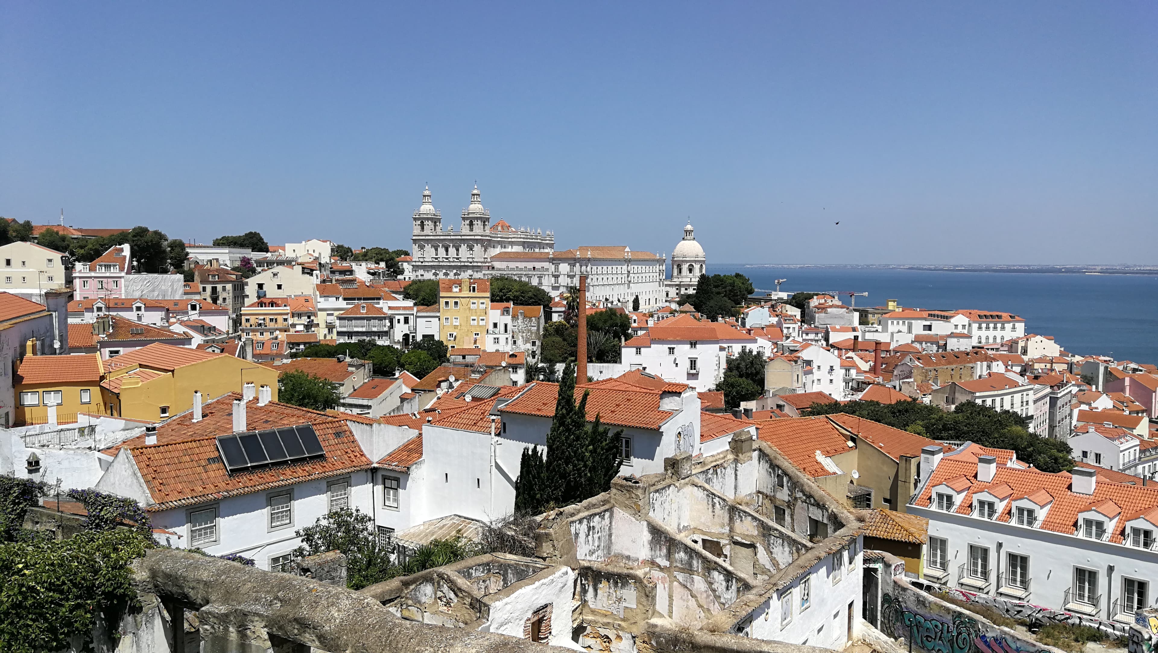 Red rooftops of Lisbon's Alfama district above the Tagus river